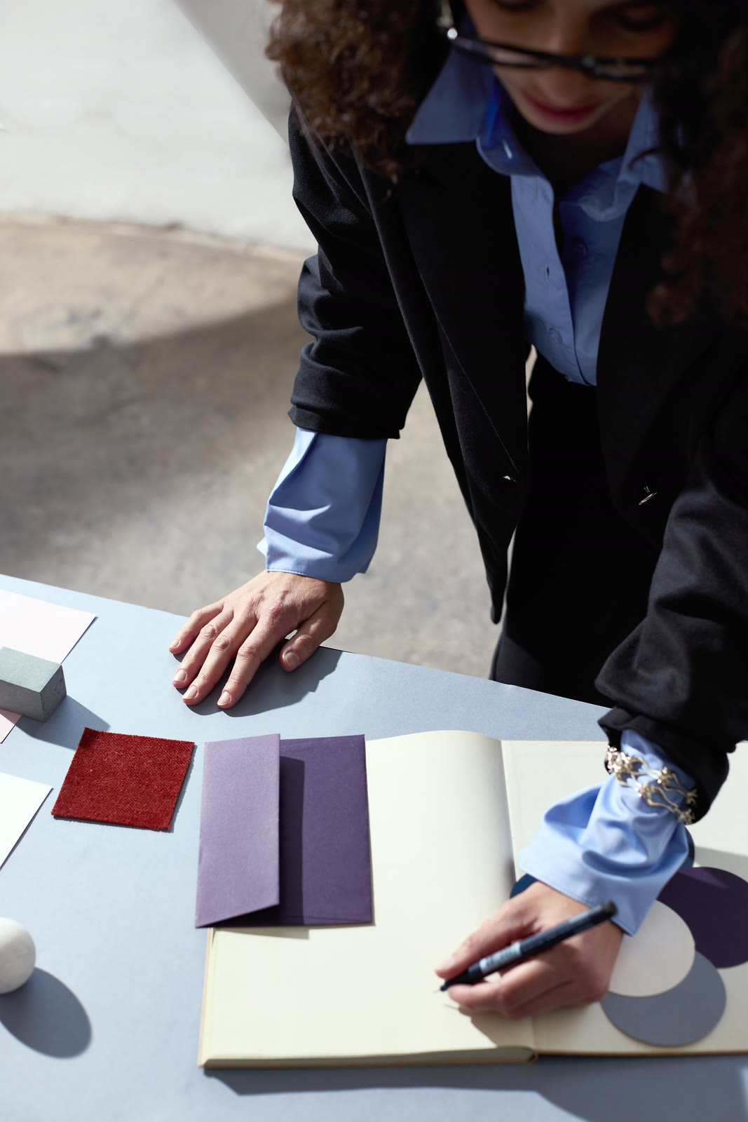 Two colleagues reviewing work together at a studio desk