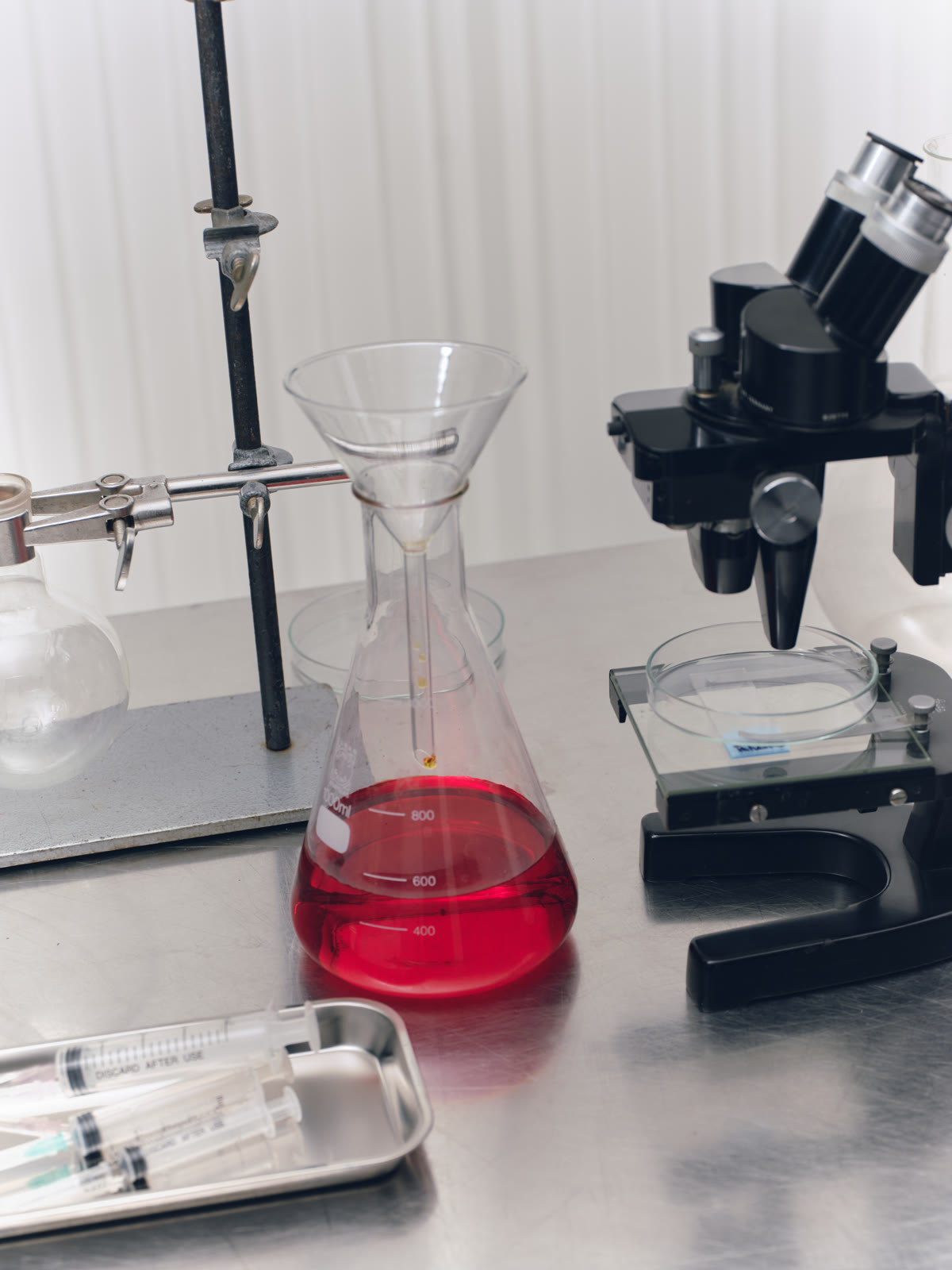 A laboratory funnel and microscope arranged on a bench
