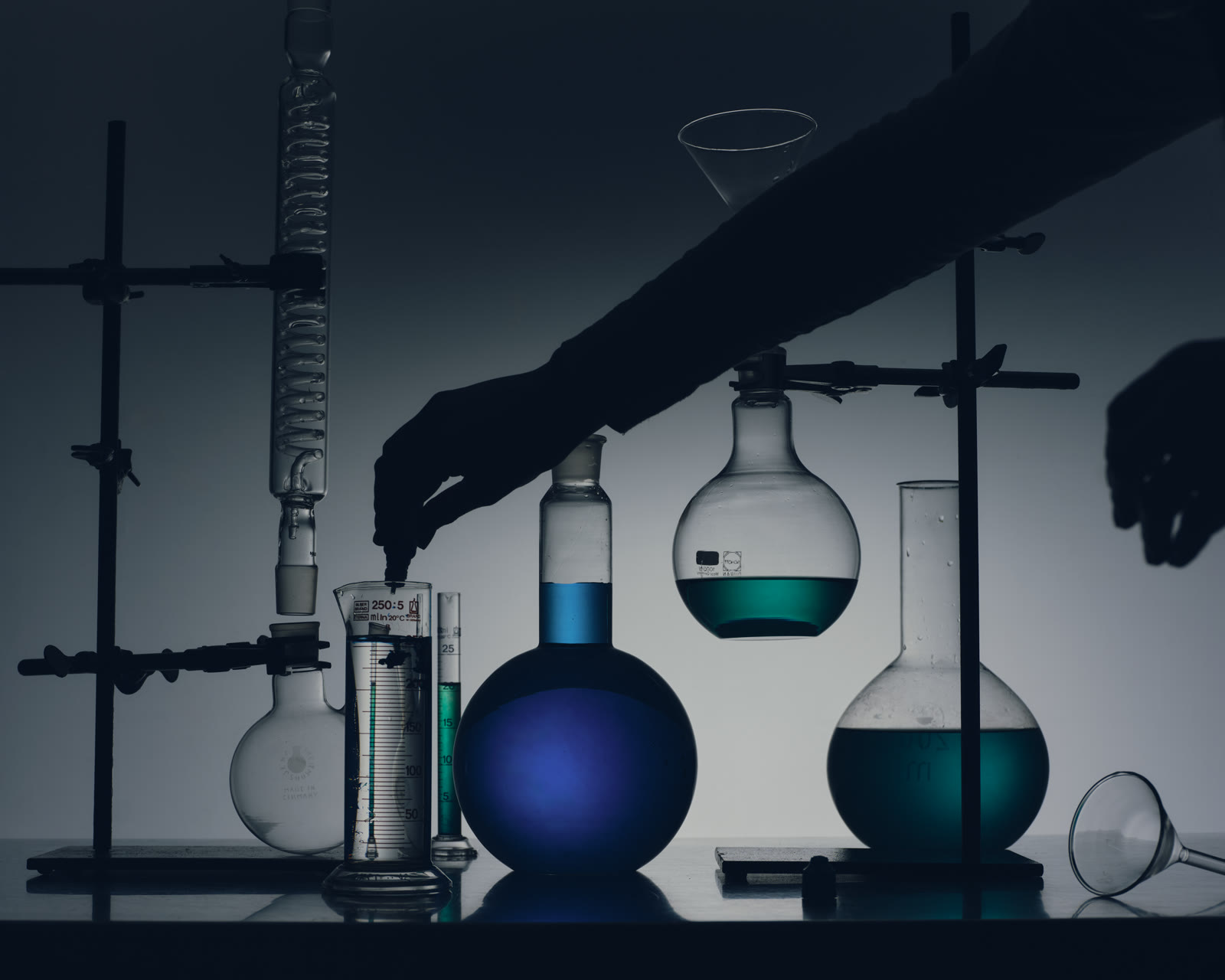 Backlit laboratory glassware in silhouette